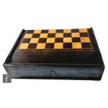 A large 19th Century ebonised boxwood folding chess board, the hinged cover revealing a later felt