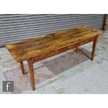 A 19th century provincial elm farm house table, the plank top over a single frieze drawer, the