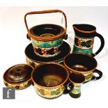 An early 20th Century Gouda toilet set comprising wash bowl and jug, two chamber pots, one slop