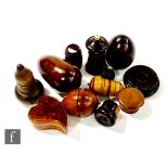 A 19th century lignum vitae taper holder, nutmeg cases, patch boxes, one of heart shaped form