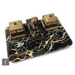An Art Deco black veined marble desk set mounted with two brass ink wells each with glass liner,