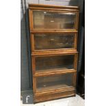 A 1920s Globe Wernicke four sectional oak bookcase enclosed by bevelled glass doors, height 181cm