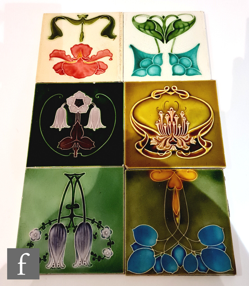 Six assorted early 20th Century 6in Art Nouveau tiles each with a stylised floral motif, to