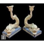 A later 20th Century pair of Wedgwood blue Jasperware Dolphin candlesticks, impressed mark alongside