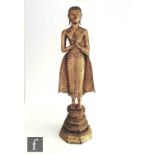 A 19th/20th Century gilt bronze/copper alloy Sino-Tibetan standing figure of Shakayumi Buddha,