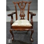 A mahogany reproduction miniature carver chair in the Chippendale style, with claw and ball front