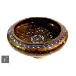 A late Qing Dynasty Chinese cloisonne bowl with folded rounded rim, raised from a high footrim,