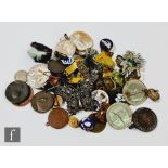 A collection of badges, some silver backed, some medallions, a gilt bracelet, a steel cut