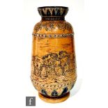 A late 19th Century Doulton Lambeth stoneware vase decorated with a wide band of incised horses,