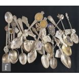 A collection of Edwardian and later commemorative teaspoons some with embossed and engraved bowls,