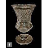 An early 20th Century Stourbridge clear cut crystal vase of waisted bell form on a plain stem and