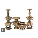 A pair of South East Asian bronze miniature candlesticks with twin elephant side handles, height