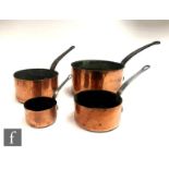 A set of four 19th Century copper iron handled saucepans. (4)