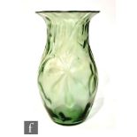 An early 20th Century Art Nouveau glass vase of ovoid form with everted rim, the body moulded in the
