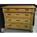 A 19th Century pine chest of four long drawers, with reeded pilasters over front bun feet, in a
