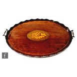 An Edwardian inlaid oval mahogany two handled serving tray, wavy edge border inlaid with a shell