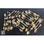 A collection of assorted silver, white metal and pewter commemorative and souvenir spoons to include