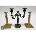 A pair of late 19th Century brass reeded column candlesticks on stepped bases, height 21cm and a