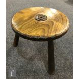 A circular stool by Harry Tonkin, the elm top carved with a lunette border and central signature