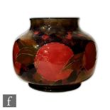 A William Moorcroft Pomegranate pattern vase of compressed ovoid form with everted rim, circa