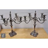 A pair of 20th century four branch candelabrums on waisted columns and stepped foliate bases, height