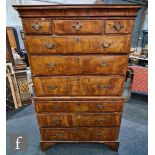 A George III cross-banded walnut chest on chest, with a cornice pediment above an arrangement of