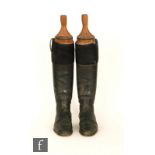 A pair of early 20th Century black leather riding boots, with a pair of beech boot trees, S/D.