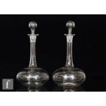 A pair of late 19th Century clear crystal decanters of compressed globe and shaft form with