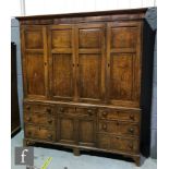 A George III oak house keeper's cupboard, the shelf interior enclosed by four crossbanded and floral