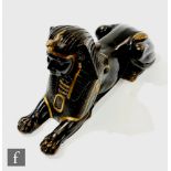A late Regency bronze figure of a Sphinx in recumbent pose wearing an Egyptian head dress with