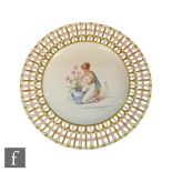 A late 19th Century Minton ribbon plate decorated to the central well with a hand painted scene of a
