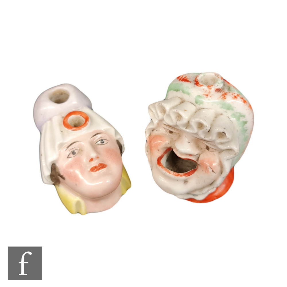 Two 19th Century Staffordshire dip pen inkwells both modelled as a female heads wearing bonnets, one