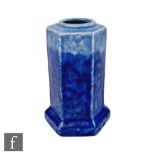 A small Ruskin Pottery vase of hexagonal form decorated in a streaked tonal blue glaze, tubed mark