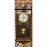 A second quarter 20th Century stained beech cased wall clock, with a silvered dial and an eight-