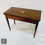 A George III mahogany rectangular tea table, inlaid with a circular fan paterae and cornered top