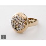 A 9ct hallmarked diamond ring with multi coloured brilliant claw set stones to an oval head,