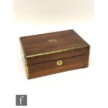 A 19th century rosewood brass bound dressing table box with fitted divisioned interior, the top