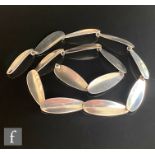 A mid 20th Century Danish silver necklet comprising fourteen elongated oval panels terminating in