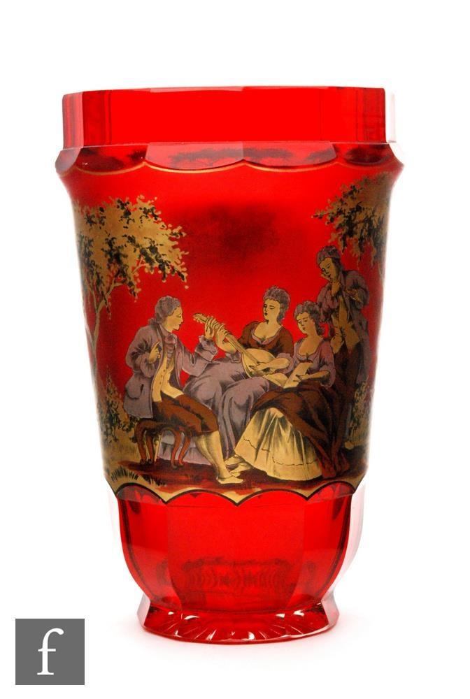 An early 20th Century Bohemian ruby glass vase of tumbler form with slice cut base and rim, the body