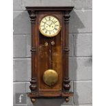 A late 19th Century walnut cased regulator wall clock by Gustave Becker, the movement enclosed by