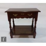 A George II style small walnut side table, fitted with brass fret drop handles, on splayed
