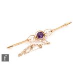 An early 20th Century 15ct bar brooch set with central amethyst flanked by seed pearls, length