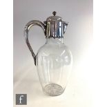 A Victorian hallmarked silver claret jug, the plain ovoid glass body below a plain silver collar,