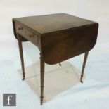 A small George III mahogany drop flap Pembroke table fitted with a single end drawer, brass turned