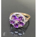 A 9ct hallmarked amethyst and diamond cluster ring, five oval claw set amethysts radiating from a