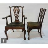A set of nine Chippendale style mahogany dining chairs, pierced splats below undulating scroll top