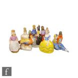 Five assorted early 20th Century continental scent bottles of varying form to include a lady stood