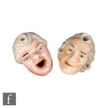 Two 19th Century Staffordshire dip pen inkwells moulded as bewigged gentlemen, the first with an