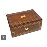 A Regency rosewood gentleman?s dressing case, the triple strung brass lid opening to reveal a red