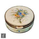A continental silver and enamel decorated circular trinket box, the hinged lid with a tied bouquet